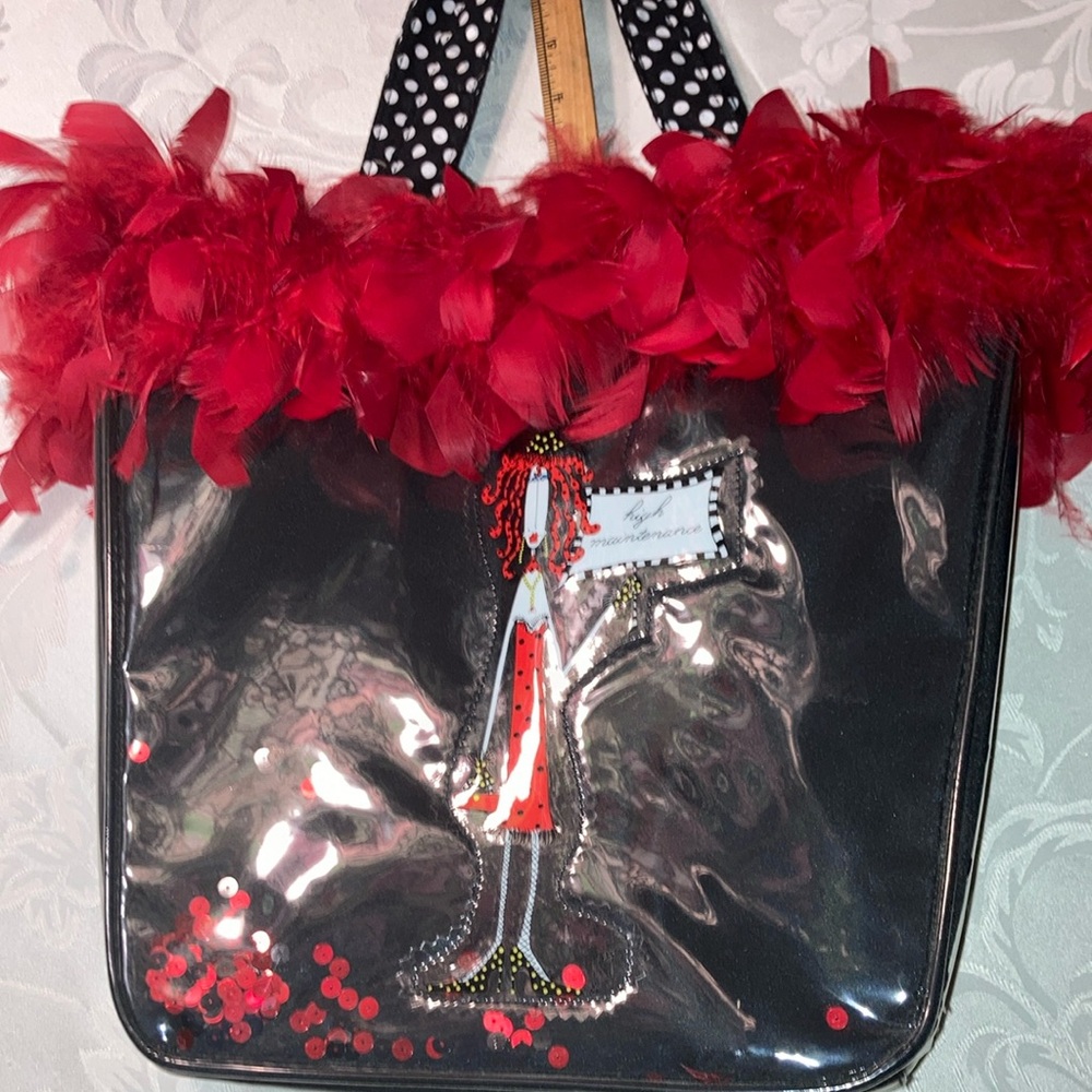 Vtg. Blk purse w/red accents, lady carries “high maintenance” sign.